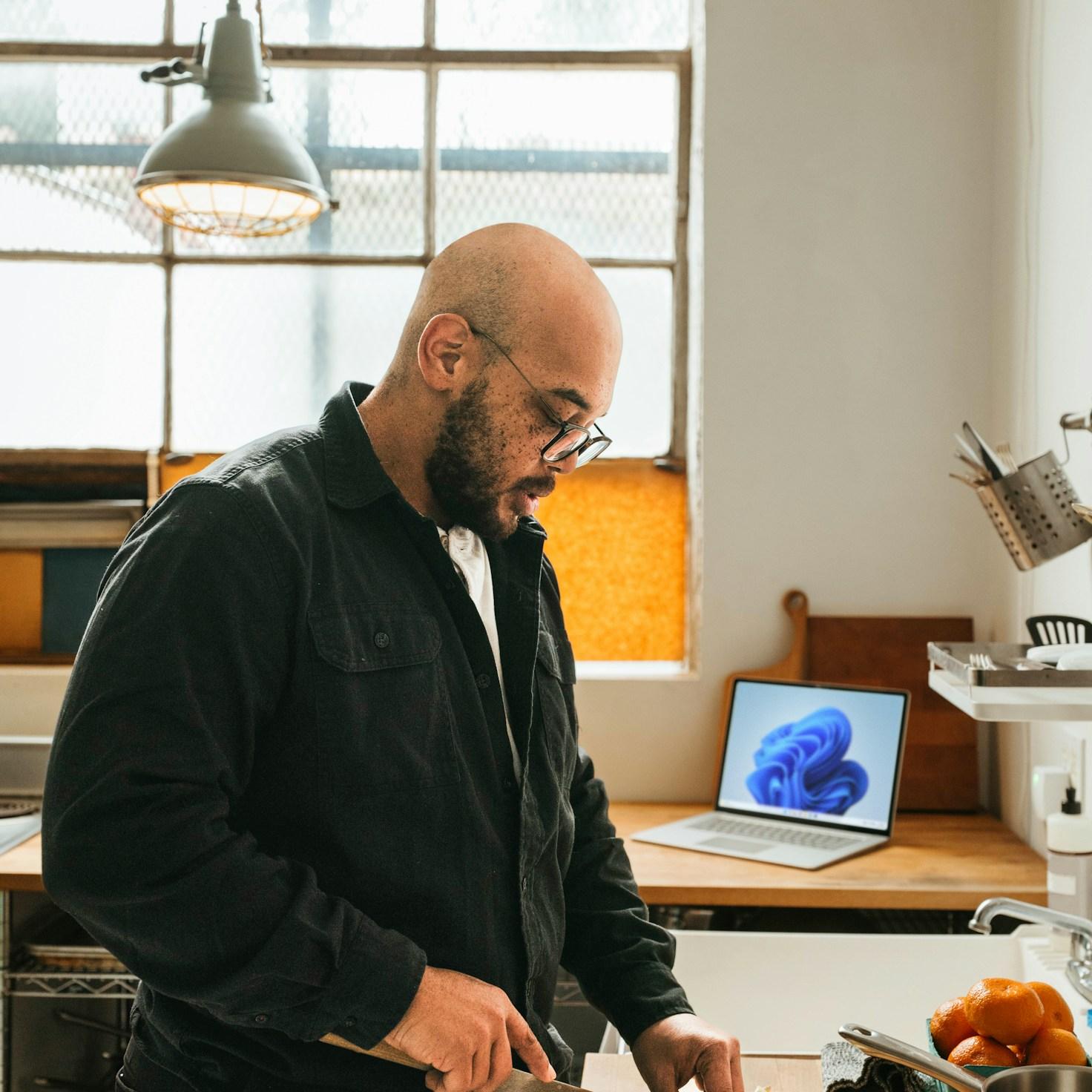 Community members collaborating in a contemporary kitchen, exchanging recipes and techniques